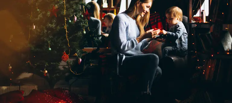Mother With Daughter By Christmas Tree