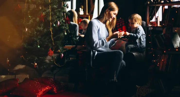 Mother With Daughter By Christmas Tree