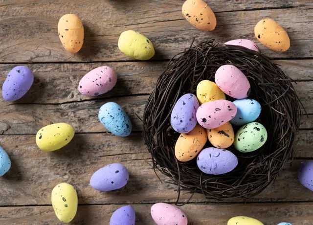 Colorful Easter Eggs Inside Nest Wooden Table